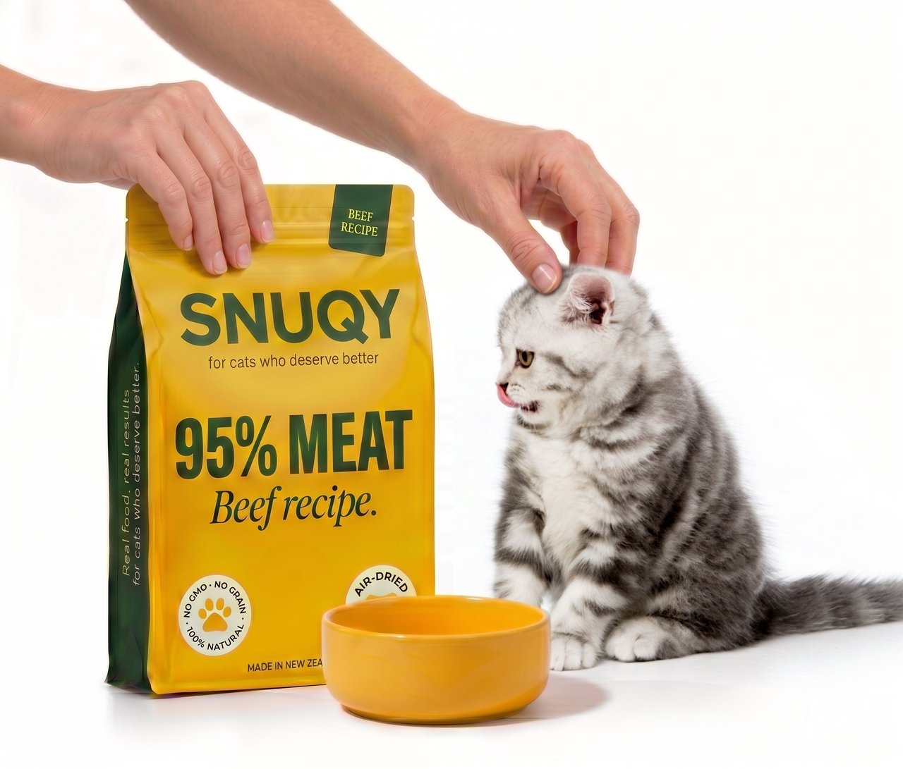 SNUQY beef recipe pouch with kitten being gently petted, ready to be served into an empty yellow bowl